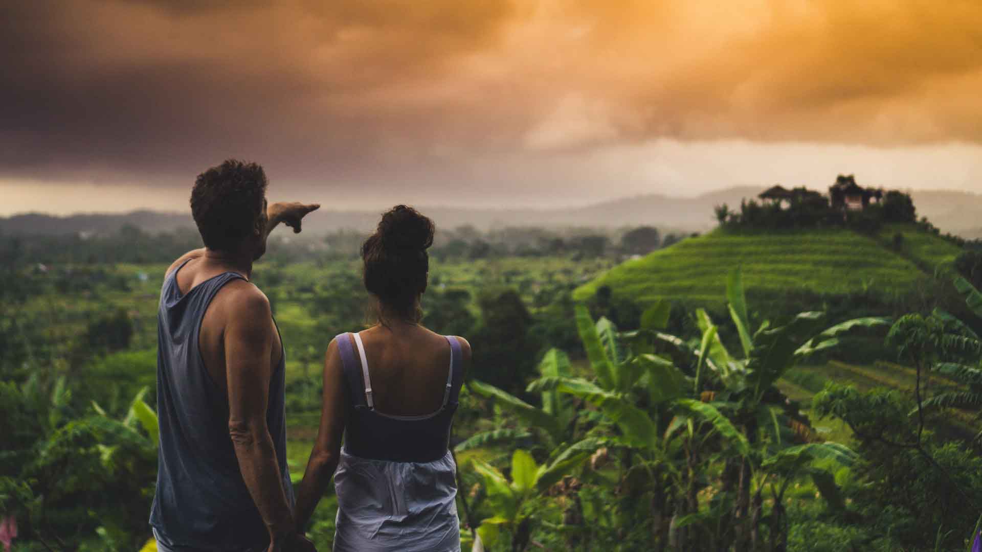 Smiling couple exploring the rolling tea plantations of Nuwara Eliya, Sri Lanka with AASH Travels local guide